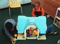 Girl and boys playing house.