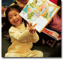 Girl showing book