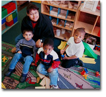 Three children and a woman in block area