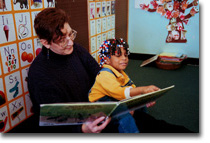 Teacher and child reading together