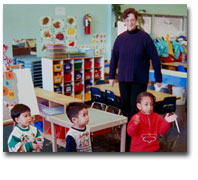 children playing with adult observing in the background