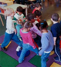 children all trying to step on a colored shape